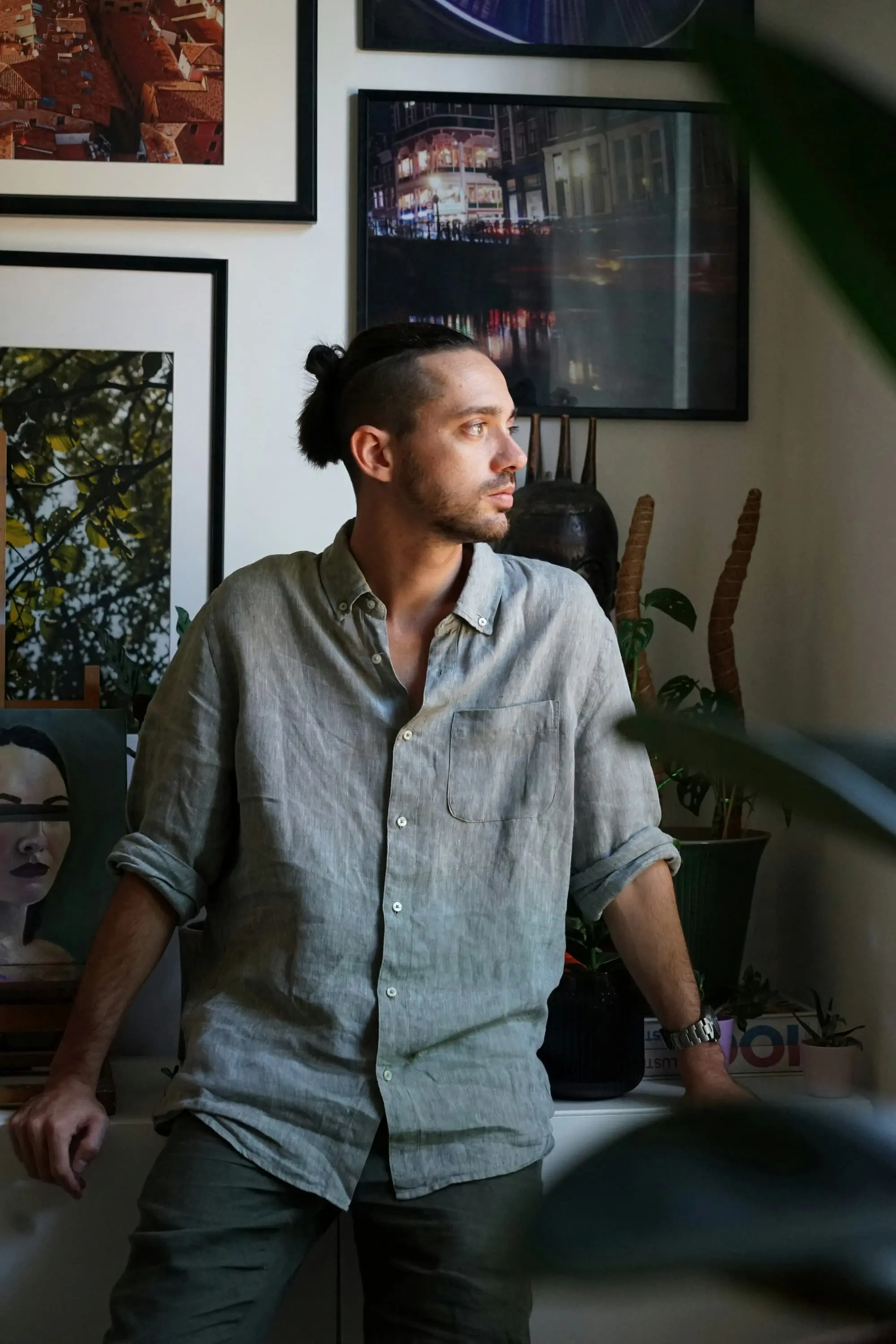 Portrait of a person in a linen shirt looking to one side