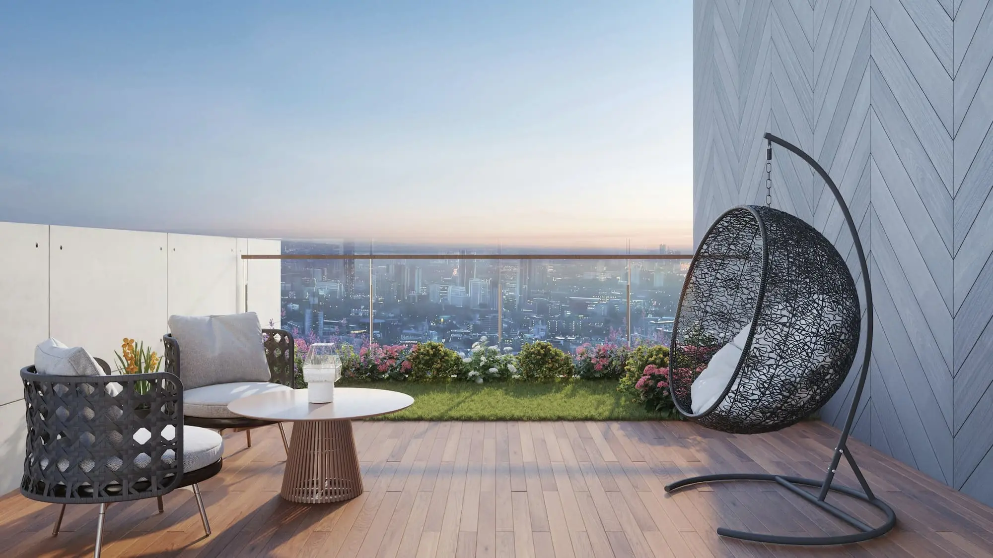 Penthouse terrace with a hanging chair, low table and a hazy city view beyond a glass balustrade