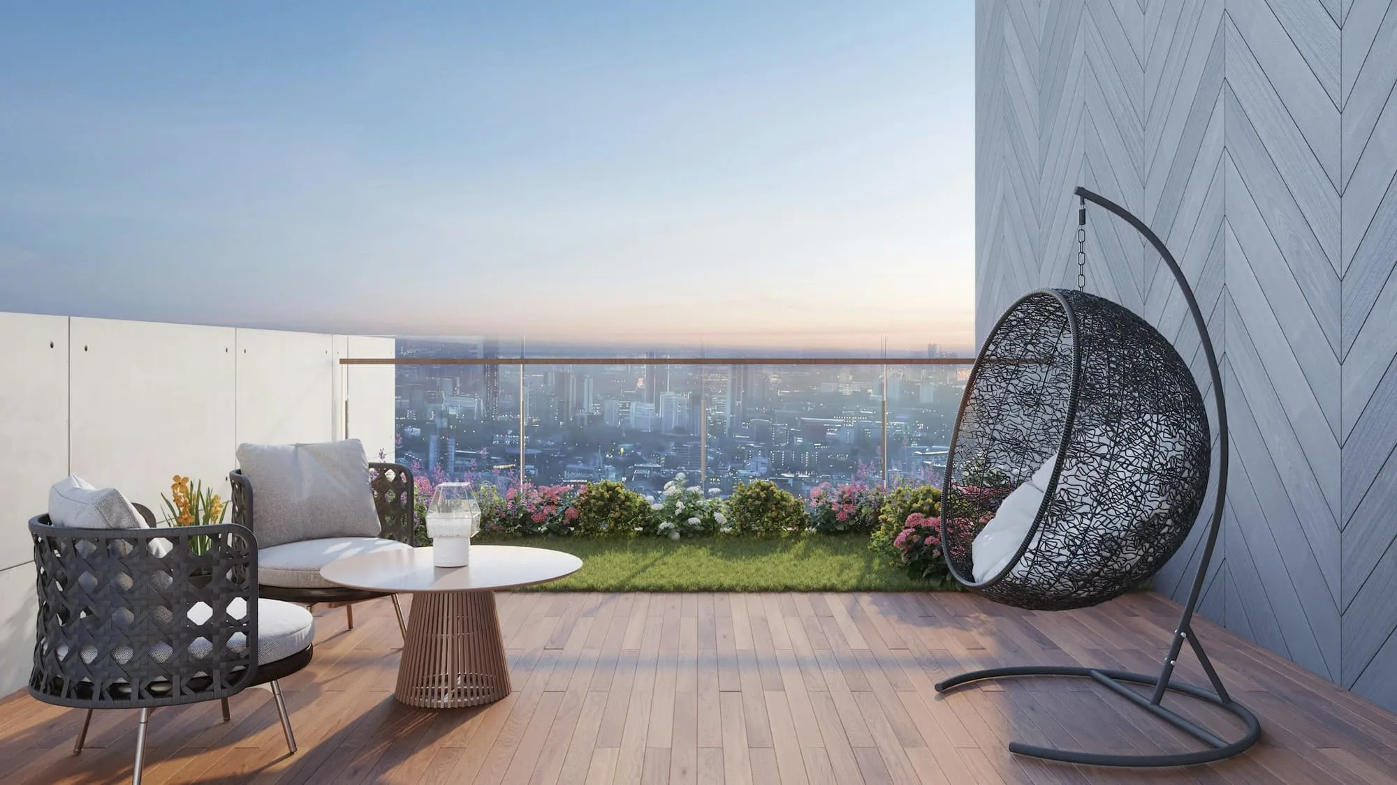 Penthouse terrace with a hanging chair, low table and a hazy city view beyond a glass balustrade