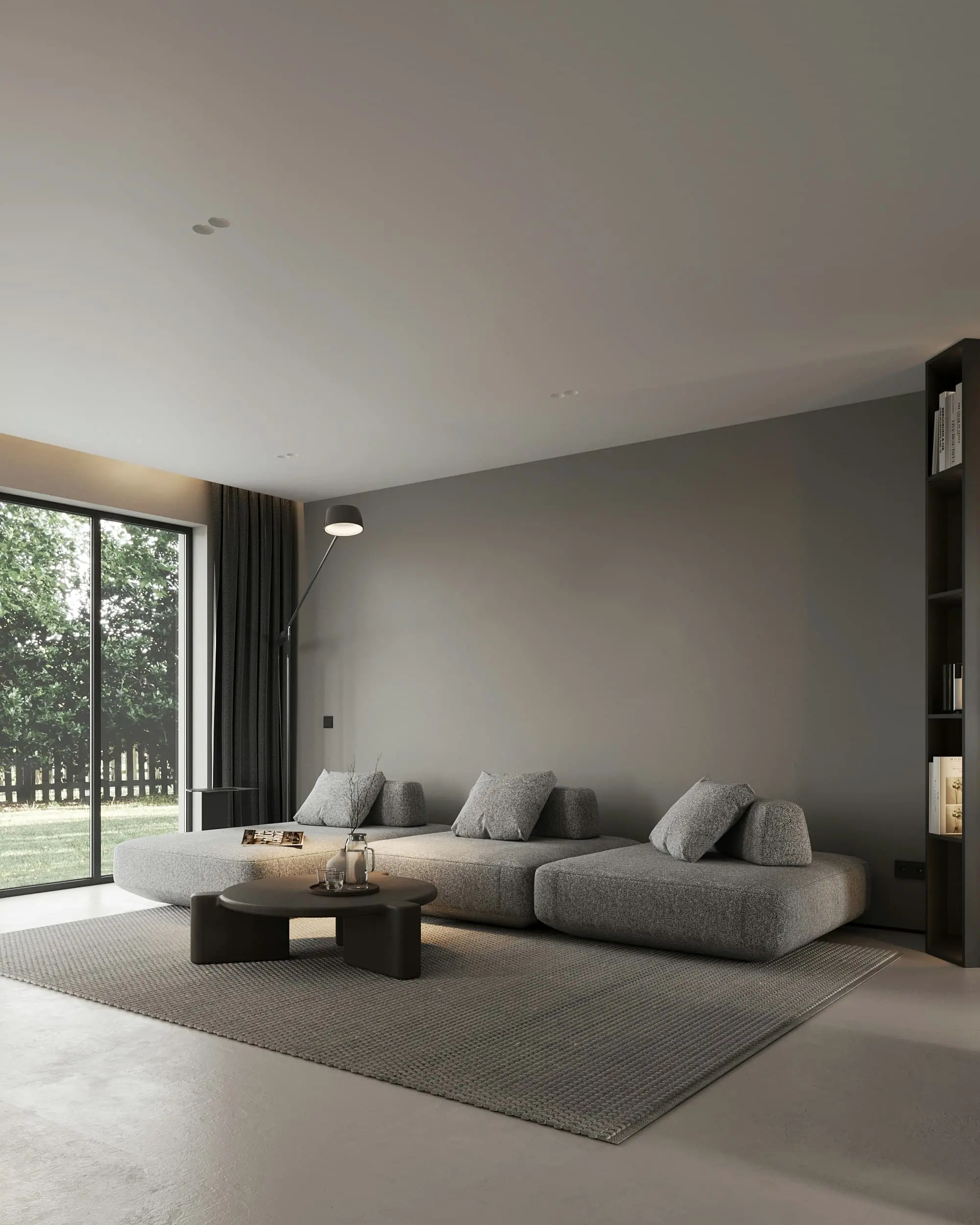Calm grey living room with a low modular sofa and a sliding door to the garden