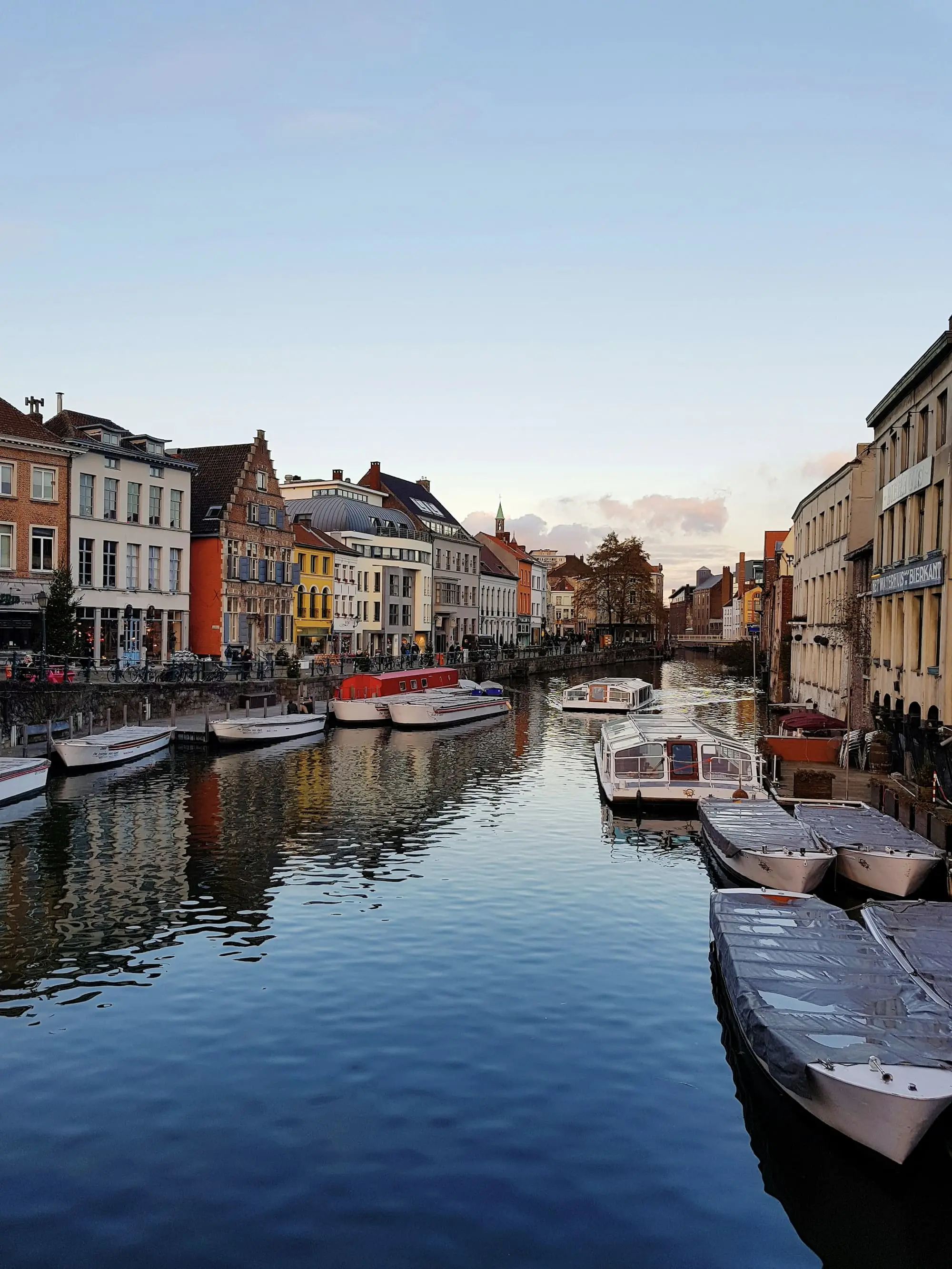 Boats along the Graslei quay in Ghent in the evening light